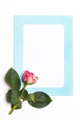 Blue card with fresh flowers. Rose. Flower arrangement. Copy space