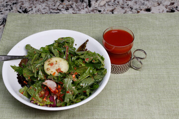 Mixed Greens Salad with Carrot Ginger Dressing in a Bowl