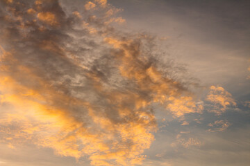 Small white clouds spread across the blue sky. Water in the form of steam.