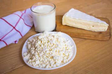 Cottage cheese, Protein and protein nutrition. cottage cheese. Homemade white cheese. Cheese on a wooden board, milk. copyspace.