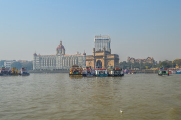 Beautiful Gateway of India near Taj Palace hotel on the Mumbai harbour with many jetties on Arabian sea