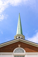 Baptist church steeple with a blue sky background