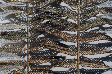 Gold and silver plastic branches on a white background