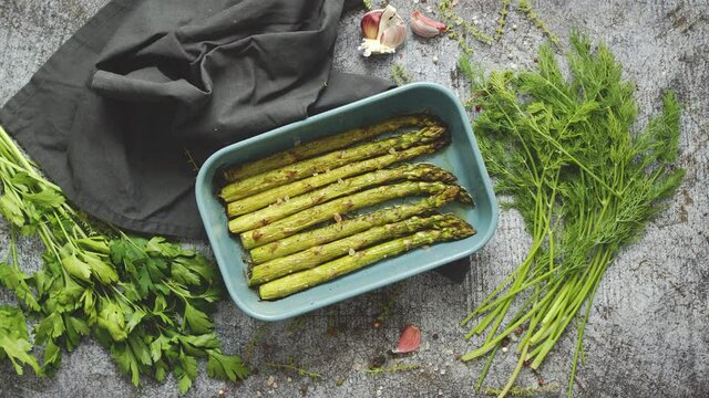 Roasted asparagus seasoned with salt, pepper, garlic and decorated with fresh herbs