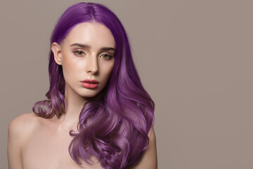 portrait of a woman with luxurious lilac hair on a gray background. Bright hair