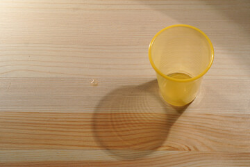 Disposable plastic cups with water on wooden background