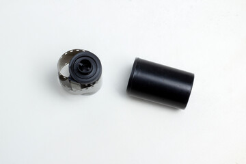 vintage photographic film with perforations in cassette on white background isolate