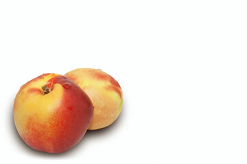 Two juicy and ripe nectarines isolated on a white background.