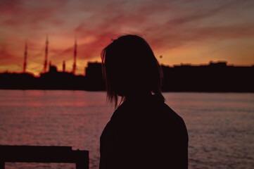 Portrait of young woman as silhouette by the sea