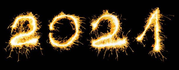 Year 2021 number written in sparklers on a black background. New Year concept.