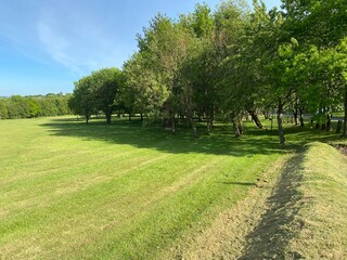 Park land with trees and green fields, set against a blue sky in, Bradford, Yorkshire, England