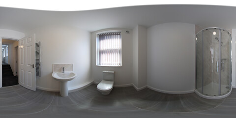 360 Degree spherical panorama sphere photo of a brand new typical British bathroom showing a corner shower, basin sink, and toilet with a wooden floor