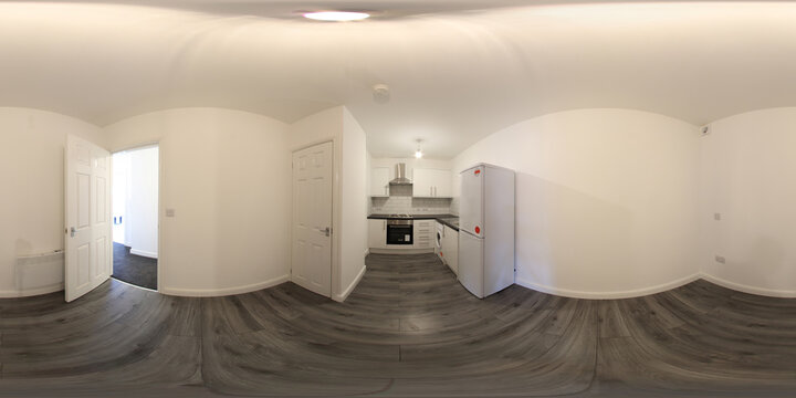 360 Degree spherical panorama sphere photo of a brand new typical British kitchen in an apartment showing the fridge, sink and washing machine