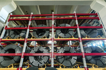Wire spools lie on multi-tiered racks.
