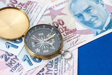 Turkish lira banknotes and compass.