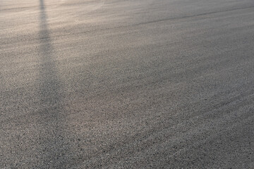 Light and shadow lines on asphalt road