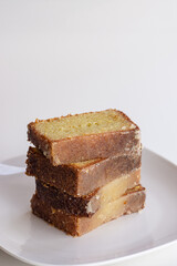 Stack Of Sweet Lemon Dessert Bread Slices On White Plate With White Background