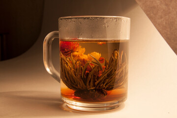 glass transparent cup with a delicious drink of herbs and flowers