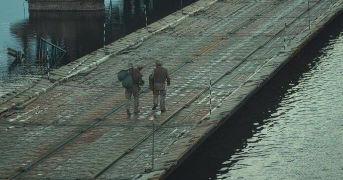 Military walk on pontoon bridge