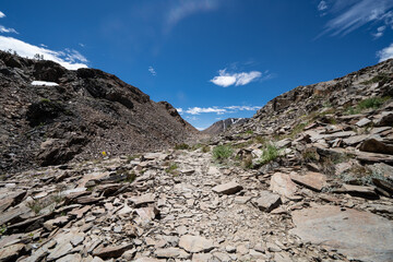 Very rocky trail of scree and talus rocks along the 20 Lakes Basin loop trail in California Eastern Sierra Nevada mountains near Tioga Pass