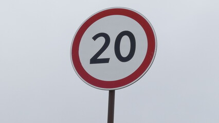 there is a speed limit sign on the road