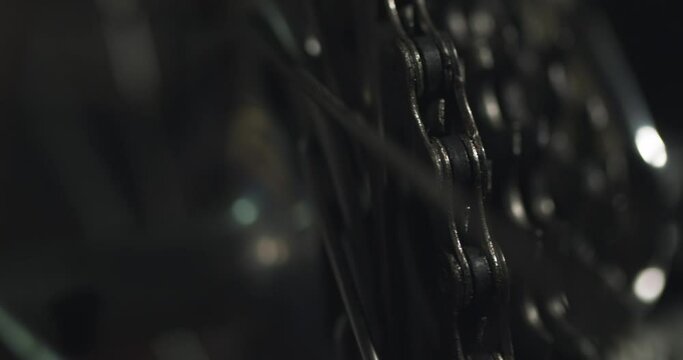 Close up of rear bicycle wheel turning, bike gears engaging, macro