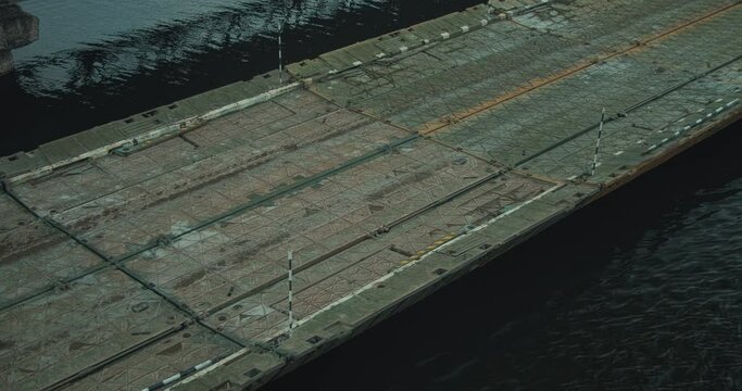 Military pontoon bridge on the river
