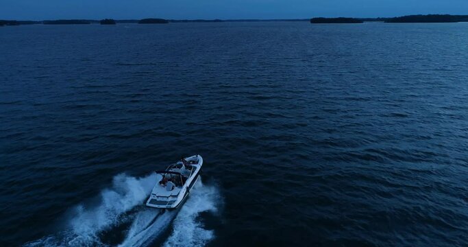 Speed boating at sunset, aerial drone shot, Lake Norman, NC
