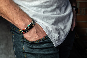Men's bracelets made of natural stones and minerals, close-up, on the hand.