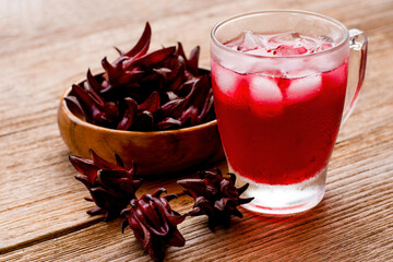 Closeup glass of roselle juice tea and  fresh red  Roselle fruit ( Jamaica sorrel, Rozelle or...