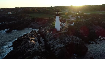 Aerial footage of the New England coastline and lighthouse in fall