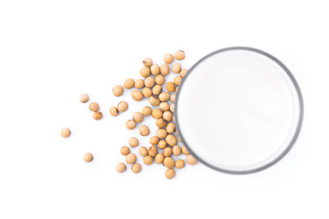 Soybeans and glass of soy milk isolated on white background. Selective focus. Top view. Flat lay.