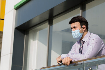 Effective protection against coronavirus. Man holding hands crossed and wearing hygienic mask