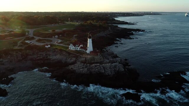 Aerial footage of the New England coastline and lighthouse in fall