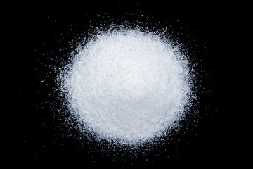 Pile of Monosodium glutamate ( MSG )  isolated on dark background. Top view. Flat lay.