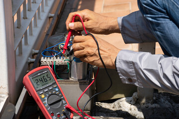 Technician man hand holding the  remote control, testing and checking the function of automatic...