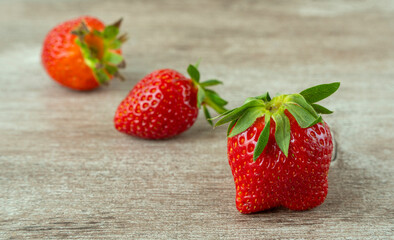 fresh strawberries on a wooden background. bright and juicy berries. source of useful substances and vitamins.