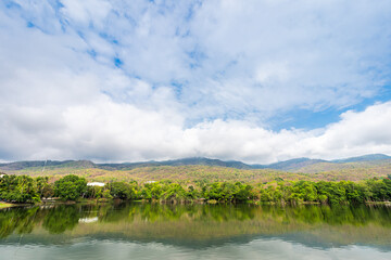 Fototapeta premium landscape lake views at Ang Kaew Chiang Mai University in nature forest Mountain views spring blue sky background with white cloud.