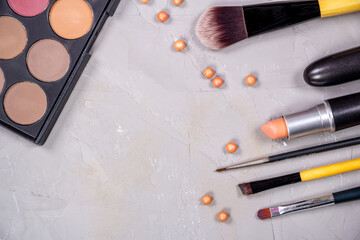 Unfolded open cosmetics on a gray background