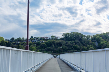 Sky with clouds and straight bridge over the river