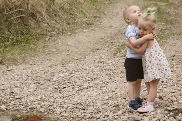 Children on a river in a forest catch fish