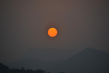 Sun with silhouette of  mountains in the evening