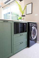 A section of kitchen room with washing machine in a home