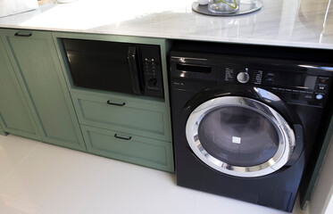 A section of kitchen room with washing machine in a home