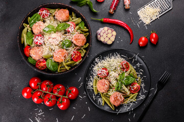 Delicious fresh pasta with meatballs, sauce, cherry tomatoes and basil
