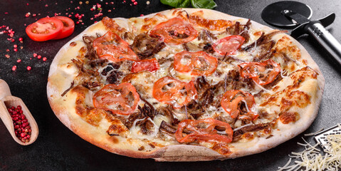 Fresh hot pizza with meat, mushrooms, cheese and tomatoes made in an oven