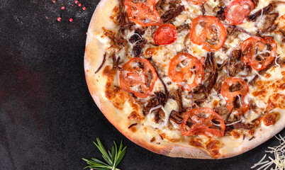 Fresh hot pizza with meat, mushrooms, cheese and tomatoes made in an oven