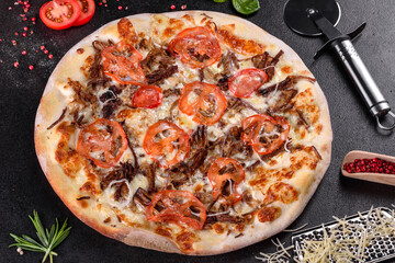 Fresh hot pizza with meat, mushrooms, cheese and tomatoes made in an oven
