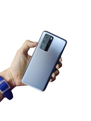 Man hand is holding new smartphone with triple-camera. Back view. Isolated on white