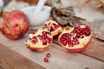 ripe organic pomegranate on teh wooden background